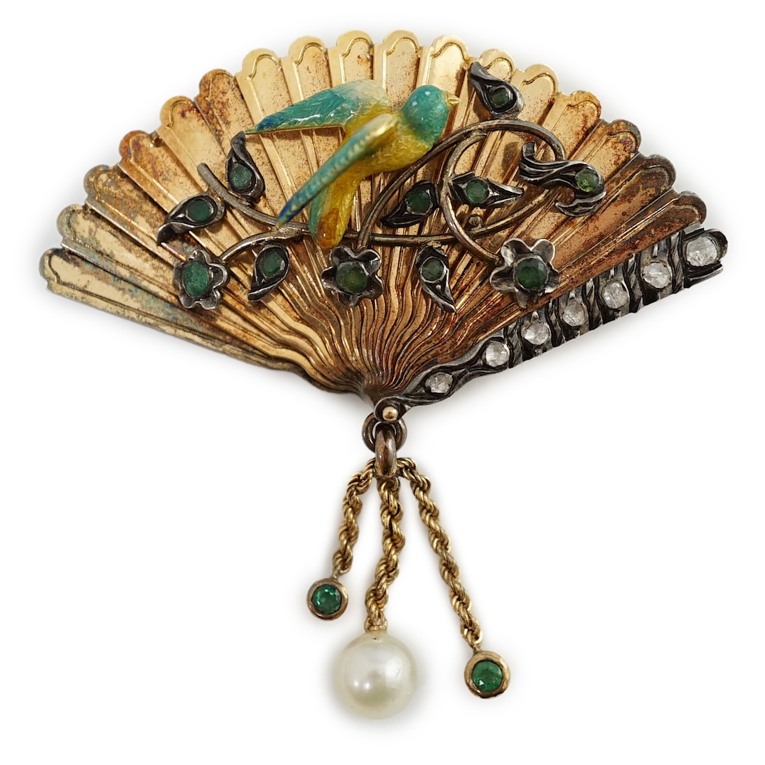 A gold (test as 15ct), emerald, rose cut diamond and enamel set brooch, modelled as a fan with applied parrot on a branch